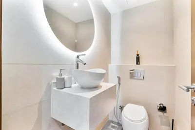 a bathroom with a sink and a toilet at Beachside Bliss With Stylish 2BR with Panoramic View in Dubai