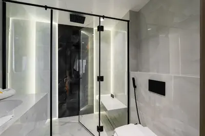 a bathroom with a glass shower and a toilet at Vogue Downtown Emaar Residence Fashion Avenue with Direct Access to Dubai Mall, Studio Apartment with Balcony Overlooking Burj Khalifa View, Access to all Amenitties in Dubai