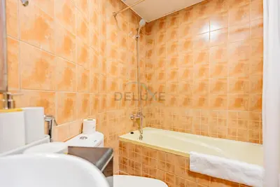 a bathroom with a tub and a toilet and a sink at Lake-View Apartment Near City Centre Meaisem Mall, Just Minutes from Dubai Autodrome and ICC Cricket Stadium - The Crescent A, Dubai Production City by Deluxe Holiday Homes in Dubai