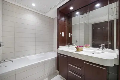 a bathroom with a tub and a sink and a tub and a mirror at Luxury 2BR in Downtown w Iconic Burj Khalifa View Burj Views 303 in Dubai