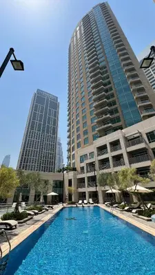a large swimming pool in front of two tall buildings at Luxury 2BR in Downtown w Iconic Burj Khalifa View Burj Views 303 in Dubai