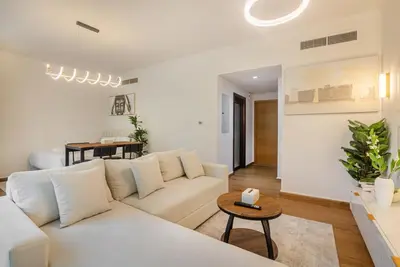 a living room with a white couch and a table at Luxury 2BR in Downtown w Iconic Burj Khalifa View Burj Views 303 in Dubai