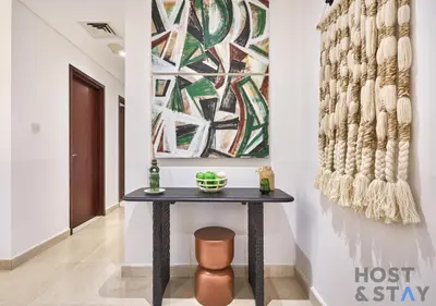 a table in a hallway with a painting on the wall at Spacious 1BR Apartment - The Jewels Tower 2 - Dubai Marina in Dubai