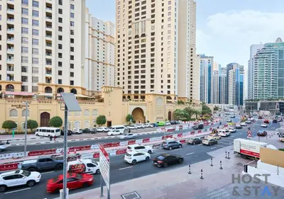 a busy city street filled with traffic with tall buildings at Spacious 1BR Apartment - The Jewels Tower 2 - Dubai Marina in Dubai