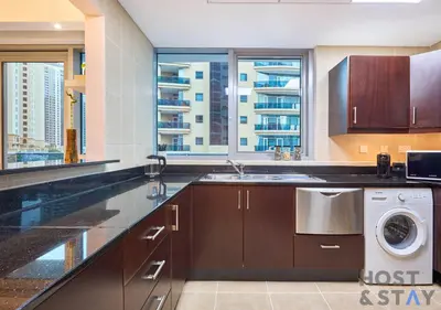 a kitchen with a sink and a washing machine at Spacious 1BR Apartment - The Jewels Tower 2 - Dubai Marina in Dubai