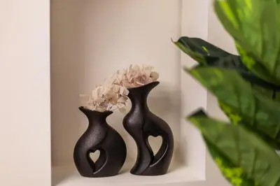 two black vases with flowers in them on a shelf at Luxurious 3BHK w Marina Views & Pool Table by dPie Sadaf 408 in Dubai