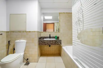 a bathroom with a toilet and a sink and a tub at Luxurious 3BHK w Marina Views & Pool Table by dPie Sadaf 408 in Dubai