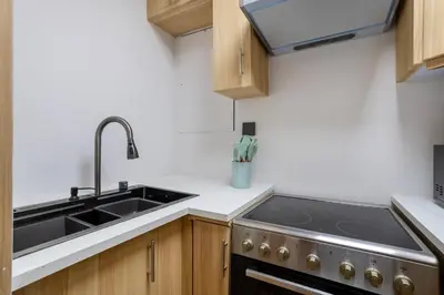 a kitchen with a sink and a stove at Luxurious 3BHK w Marina Views & Pool Table by dPie Sadaf 408 in Dubai