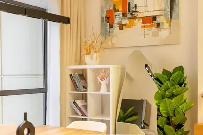 a living room with a book shelf with books at Luxurious 3BHK w Marina Views & Pool Table by dPie Sadaf 408 in Dubai
