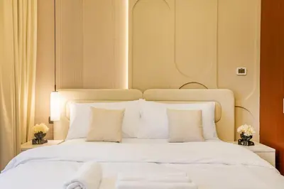 a large bed with white sheets and pillows at Luxurious 3BHK w Marina Views & Pool Table by dPie Sadaf 408 in Dubai