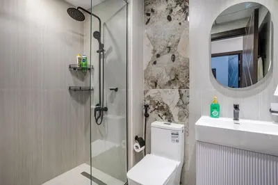 a bathroom with a shower and a toilet and a sink at Luxury 2 BR in Al Barsha Opalz Danube by dpie A312 in Dubai