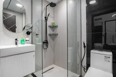 a bathroom with a shower and a toilet and a sink at Luxury 2 BR in Al Barsha Opalz Danube by dpie A312 in Dubai
