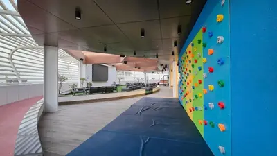 a climbing wall in an office with a climbing wall at Luxury 2 BR in Al Barsha Opalz Danube by dpie A312 in Dubai