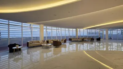 a lobby with couches and tables in a building at Luxury 2 BR in Al Barsha Opalz Danube by dpie A312 in Dubai