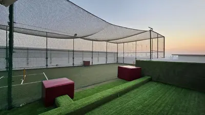 a tennis court with a net on a tennis court at Luxury 2 BR in Al Barsha Opalz Danube by dpie A312 in Dubai
