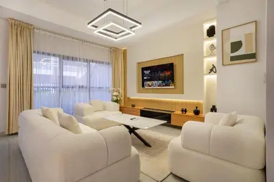 a living room with two white couches and a table at Luxury 4 BHK Villa in JVC by dPie in Dubai