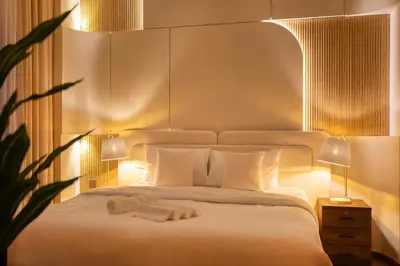 a bedroom with a white bed with two towels on it at Luxury 4 BHK Villa in JVC by dPie in Dubai
