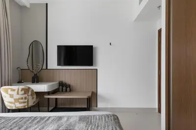 a bedroom with a sink and a mirror and a chair at Ultra Luxury Emaar Palace Beachfront 1BR Five Palm in Dubai