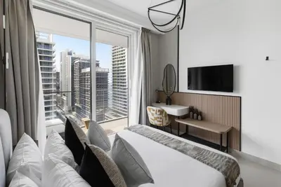 a hotel room with a bed and a large window at Ultra Luxury Emaar Palace Beachfront 1BR Five Palm in Dubai