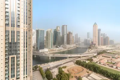 a view of a city with a river and buildings at ALiving Luxury 1BR Apartment with City View I Amna Tower, Al Habtoor City in Dubai