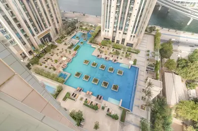 an overhead view of a pool in a city at ALiving Luxury 1BR Apartment with City View I Amna Tower, Al Habtoor City in Dubai
