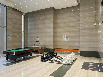 a billiard room with a table and chessboard at ALiving Luxury 1BR Apartment with City View I Amna Tower, Al Habtoor City in Dubai