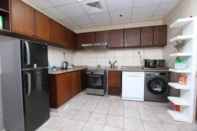 a kitchen with a refrigerator and a dishwasher at Premium Ensuite Room With Balcony in Dubai