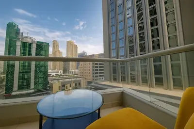 a balcony with a table and chairs and a view of the city at Premium Ensuite Room With Balcony in Dubai