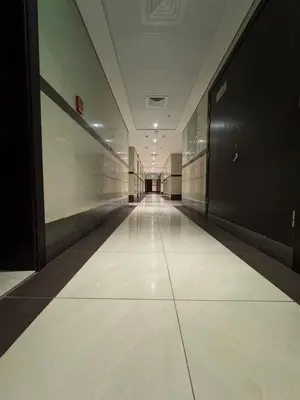 an empty hallway in a building with a long corridor at Modern Studio Apartment in Dubai Sports City in Dubai