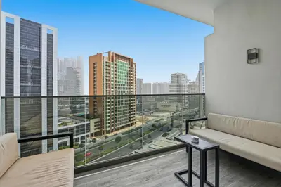 a living room with a couch and a view of the city at Downtown Dubai, Canal view ,Mag318 in Dubai