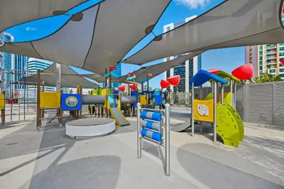 a playground with blue and yellow swings at Downtown Dubai, Canal view ,Mag318 in Dubai
