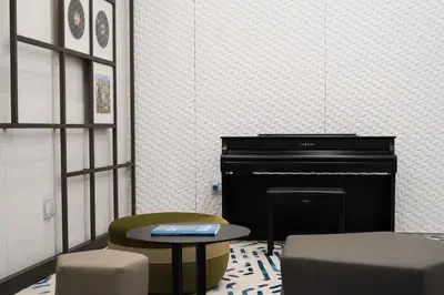 a room with a piano and a table and chairs at BRAND NEW FULL MARINA VIEW 1BR Apartment at LIV Marina in Dubai