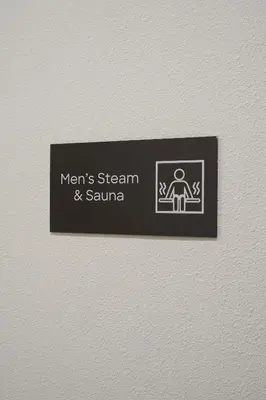 a sign on a wall with a man sitting on a chair at BRAND NEW FULL MARINA VIEW 1BR Apartment at LIV Marina in Dubai