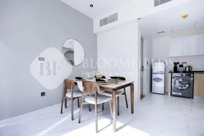 a dining room with a table and chairs at Bloomfields Deluxe 1br Rukan in Dubai