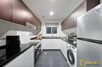 a large kitchen with a sink and a dishwasher at Luxurious 3BR Villa Getaway in DH2 by Deleguest in Dubai