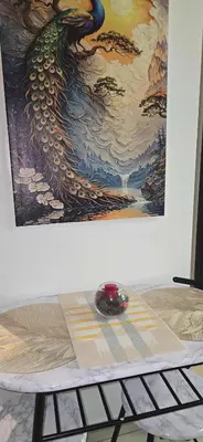 a painting of a phoenix on a wall next to a table at Stunning I Biggest Studio I Near To Downtown in Dubai