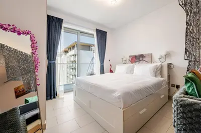 a bedroom with a large white bed and a window at Stunning I Biggest Studio I Near To Downtown in Dubai