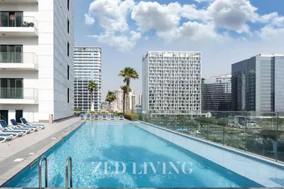 a swimming pool on the roof of a building at Sol Bay - Stay in style with Burj Khalifa views - Zed Living in Dubai