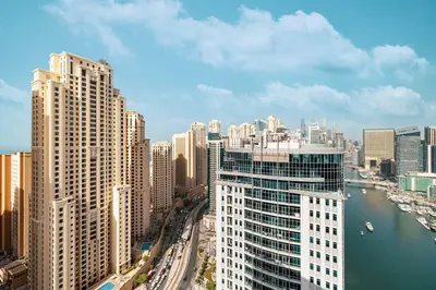 a view of a city with a river and buildings at Luxury 4 Bedroom Penthouse in Dubai Marina in Dubai