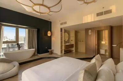 a large bathroom with a tub and a sink and a bath tub at Luxury 4 Bedroom Penthouse in Dubai Marina in Dubai