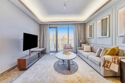 a living room with a couch and a tv at Premium 5 bedroom penthouse opposite Burj Khalifa in Dubai