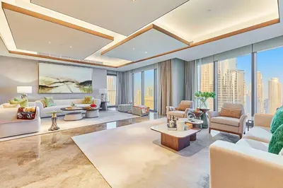 a living room with a lot of furniture and windows at Premium 5 bedroom penthouse opposite Burj Khalifa in Dubai