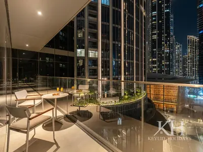 a balcony with a table and chairs on a building at keylid-2BR-Address Opera-5 mins walk to Dubai Mall in Dubai