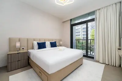 a bedroom with a large bed and a large window at Dubai Hills Townhouse in Dubai