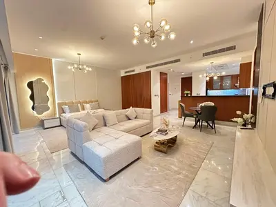 a living room with a white couch and a table at Central Park towers residence difc in Dubai