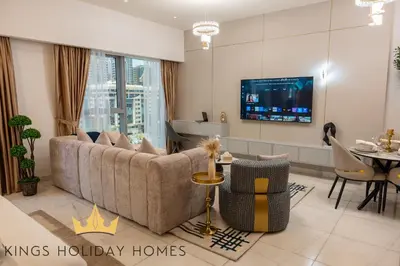 a living room with a couch and a tv at Central Park towers residence difc in Dubai