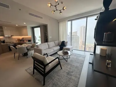a living room with a couch and a table at Royal suite at Liv marina views in Dubai