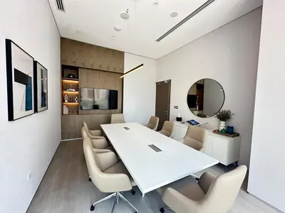 a dining room with a white table and chairs at Royal suite at Liv marina views in Dubai