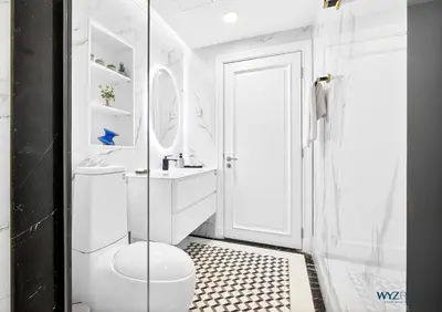 a white bathroom with a toilet and a shower at Arabian Elegance 1BR Zanzabeel 1 Burj Khalifa View in Dubai