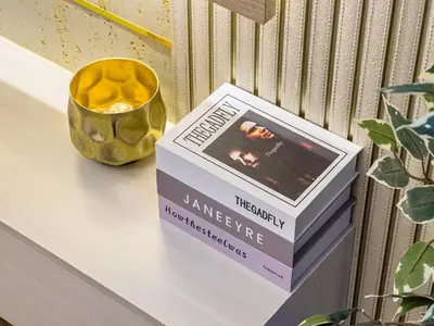 a book sitting on a shelf next to a vase at Elegant Oasis - 15 min to Burj Khalifa and Aiport - 1 BDR - 4 pax in Dubai